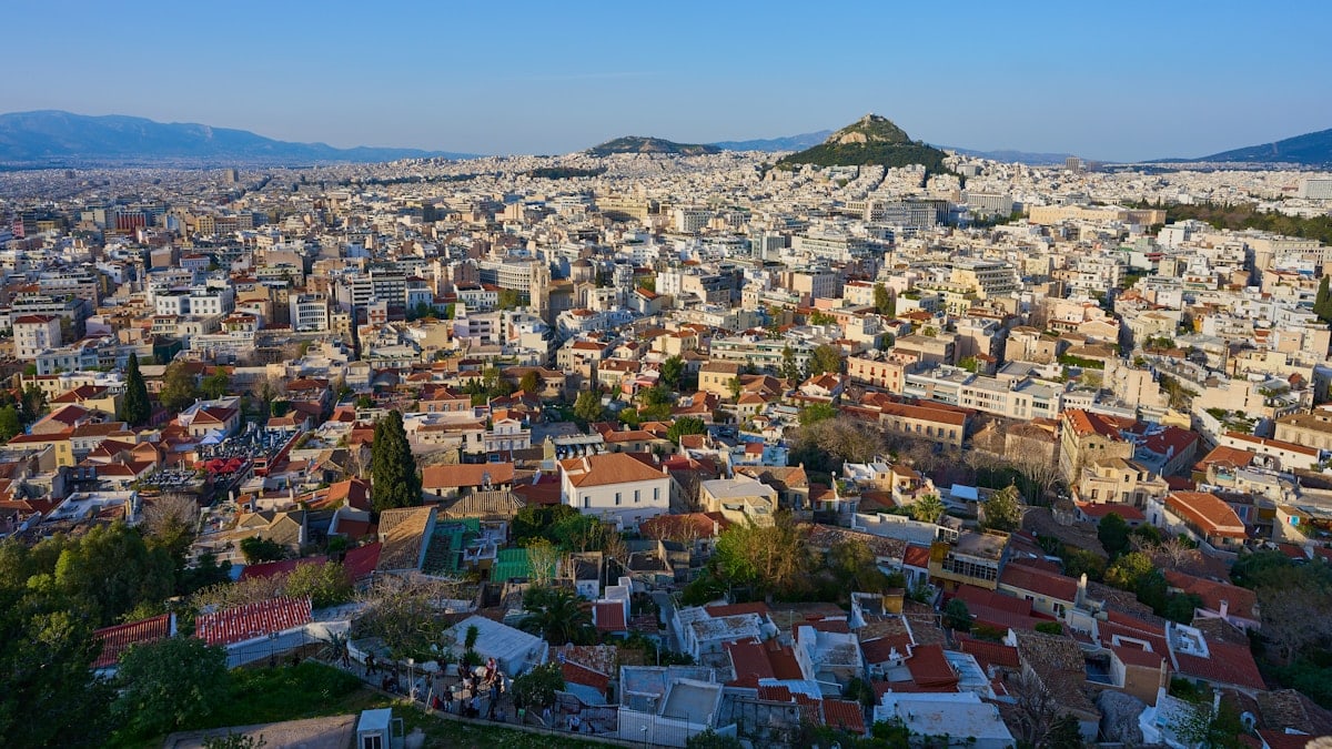 Aerial view of a sprawling city with distant hills.